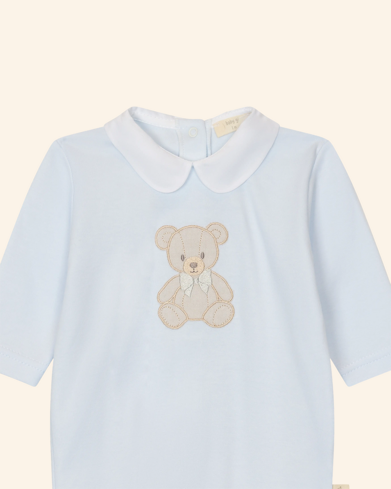 LilleLuxus Babygi blue interlock cotton baby romper featuring a cute embroidered teddy bear and a white Peter Pan collar