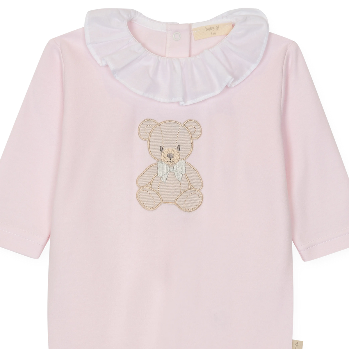LilleLuxus Babygi pink interlock cotton baby onesie with a cute teddy bear motif and a white ruffled collar.