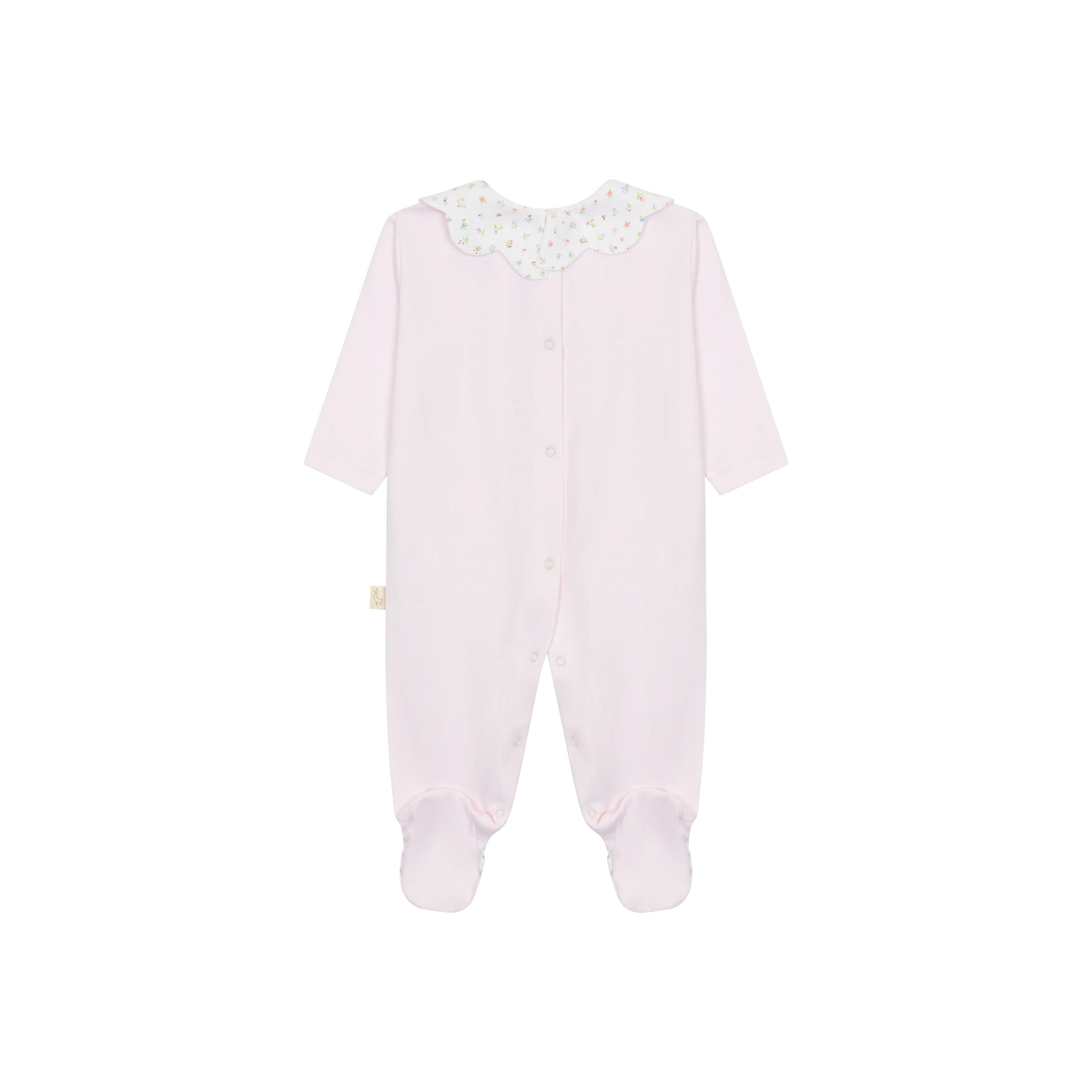 LilleLuxus baby footed sleeper in soft pink interlock cotton with a delicate floral scalloped collar, back view.